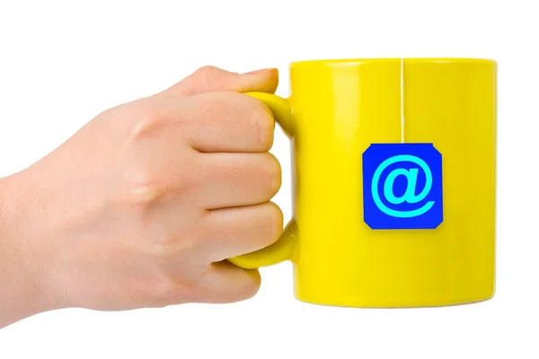 Hand and cup of tea with at symbol — Stock Photo, Image