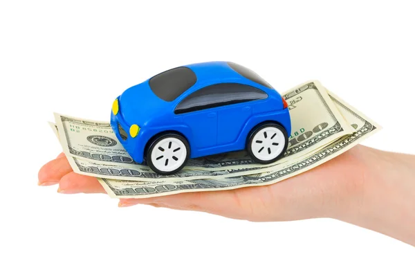 Mão com dinheiro e carro de brinquedo — Fotografia de Stock