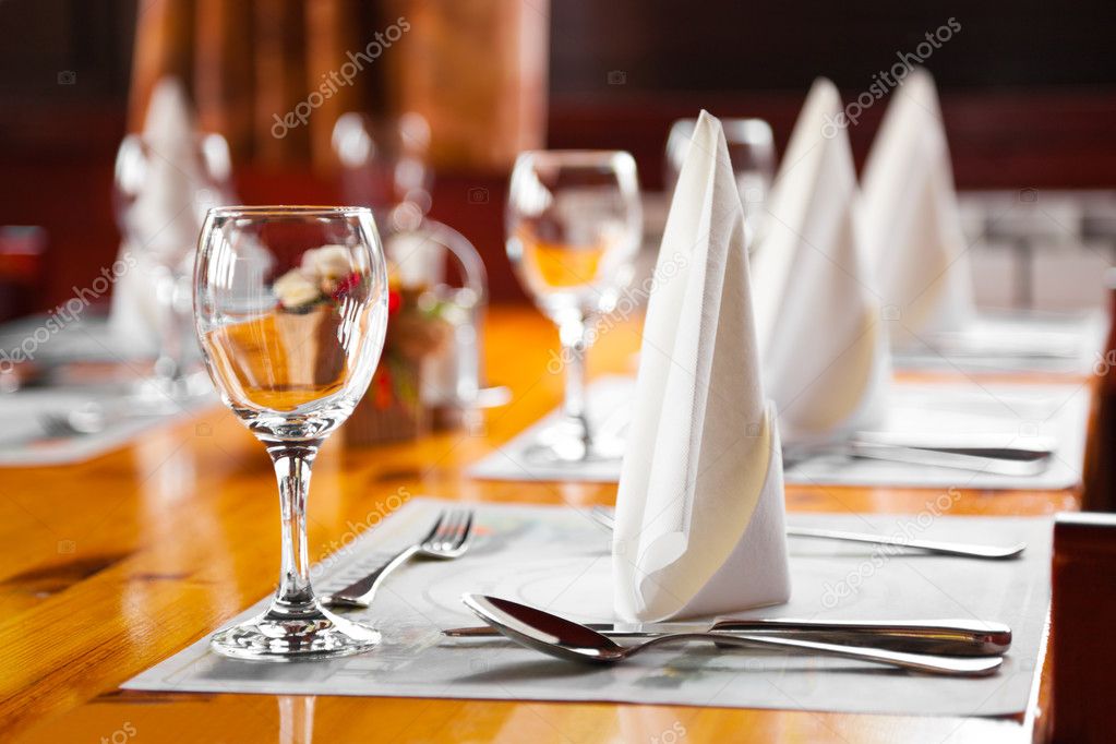 Glasses and plates on table in restaurant