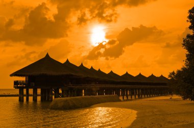 Water bungalows and sunset clipart