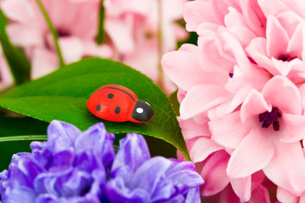 stock image Toy ladybug and flowers