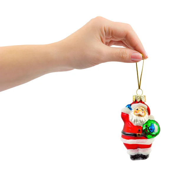 Rukou a vánoční hračky santa — Stock fotografie