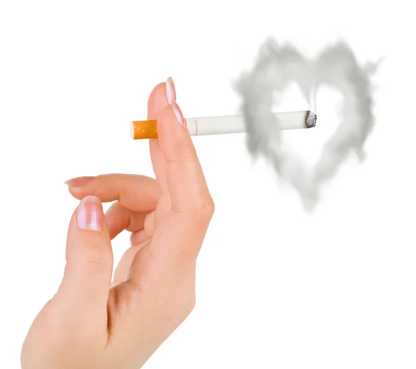 Mão com cigarro e fumaça em forma de coração — Fotografia de Stock