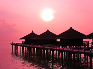 Water bungalows and sunset clipart