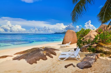 Chairs on tropical beach clipart