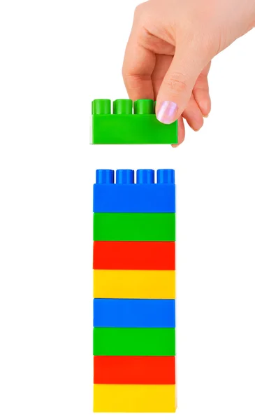 Hand and toy tower — Stock Photo, Image