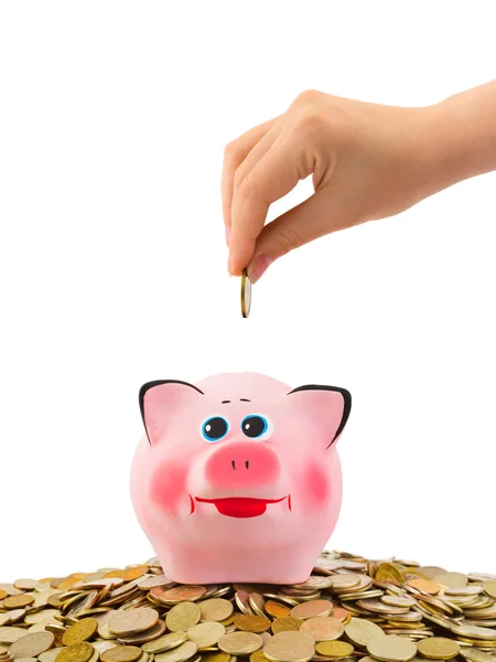 Piggy bank and hand with coin — Stock Photo, Image