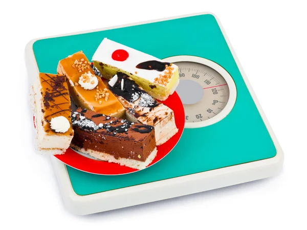 Cakes on weight scale — Stock Photo, Image
