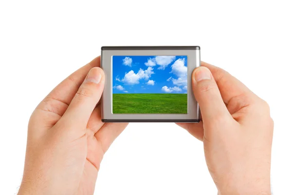 Screen with landscape in hands — Stock Photo, Image