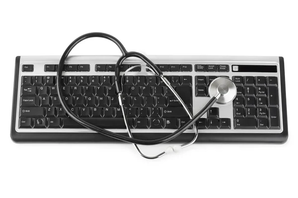 Estetoscópio e teclado de computador — Fotografia de Stock