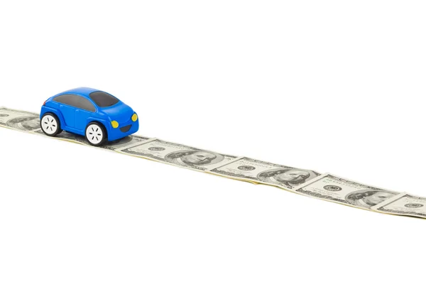 Carro de brinquedo na estrada do dinheiro — Fotografia de Stock