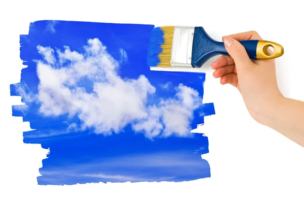 Hand with paintbrush painting sky — Stock Photo, Image