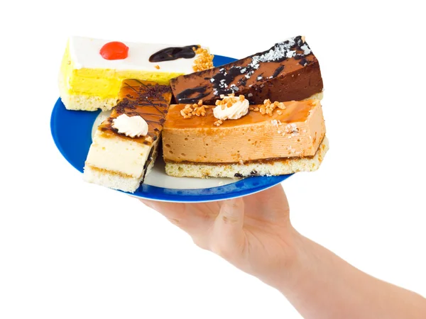 Mano y plato con pasteles —  Fotos de Stock