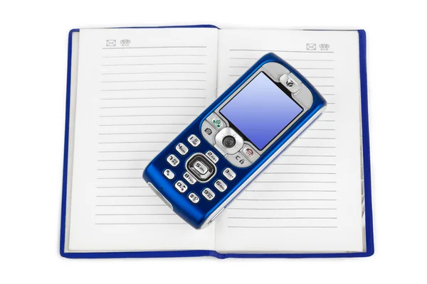 Teléfono móvil en el libro — Foto de Stock