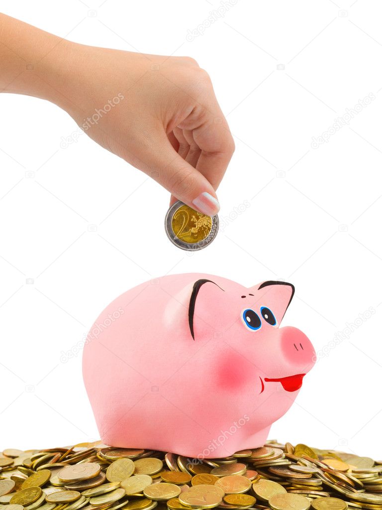 Piggy bank and hand with coin