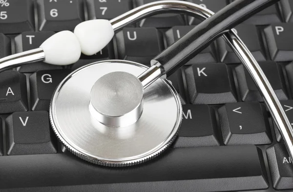 stock image Stethoscope and computer keyboard