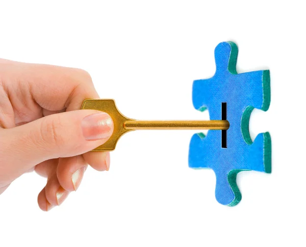 Hand with key and puzzle — Stock Photo, Image