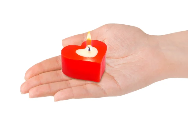 Herzförmige Kerze in der Hand — Stockfoto
