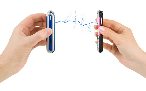 Hands and connected mobile phones — Stock Photo, Image