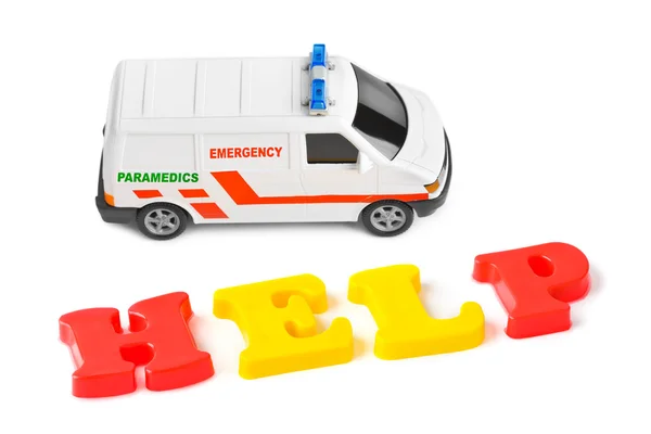 Oyuncak ambulans araba ve word yardım — Stok fotoğraf