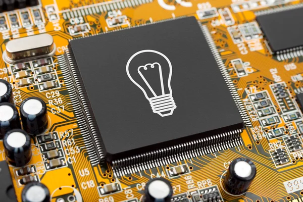 Bulb on computer chip — Stock Photo, Image