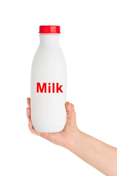 Ruka s lahvičkou mléka — Stock fotografie