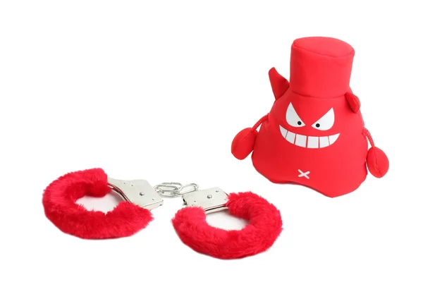 Червоні наручники, злі іграшки — стокове фото