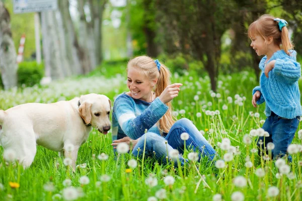 Woman with girl and dog — Stock Photo, Image