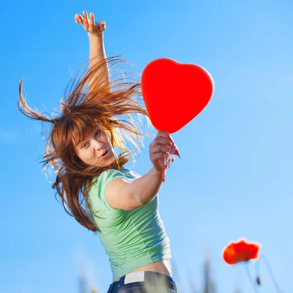 Jumping girl with heart — Stock Photo, Image