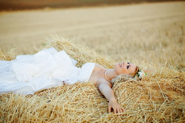 Bride in hay stack — Stock Photo, Image