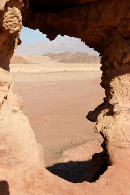 Window in sandstone rock in desert clipart