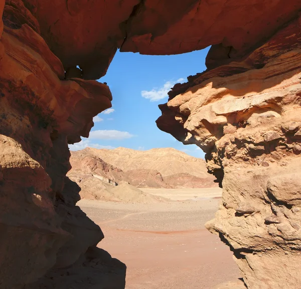 Window in orange sandstone rock in desert