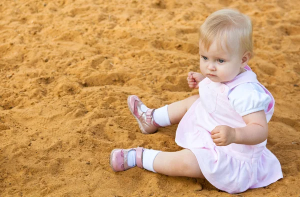 Little girl in sandbox — Stock Photo, Image