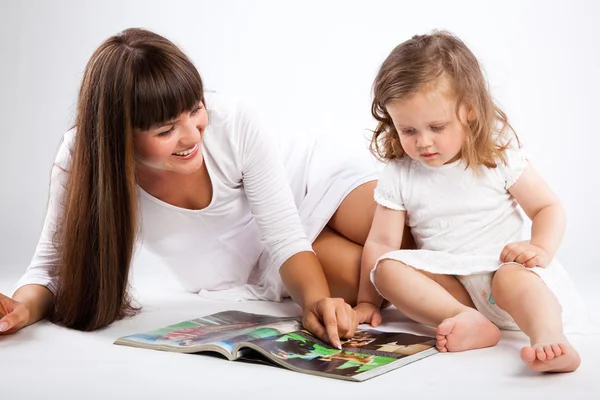 Mother and little daughter reading book — Stock Photo, Image