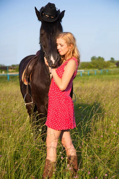 Young blond woman with horse — Stok fotoğraf