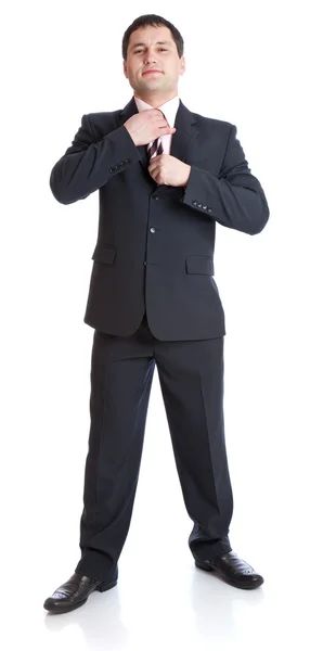 El hombre de negocios endereza la corbata. Aislado sobre fondo blanco — Foto de Stock