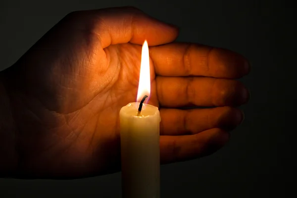 Hand keeps burninging candle — Stock Photo, Image