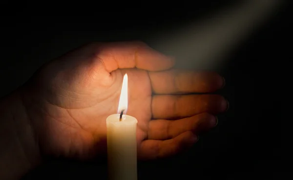 Hand keeps burninging candle — Stock Photo, Image