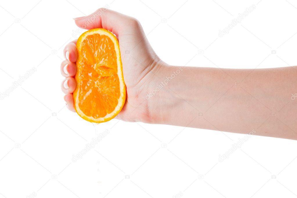 Hand squeezing an half of orange