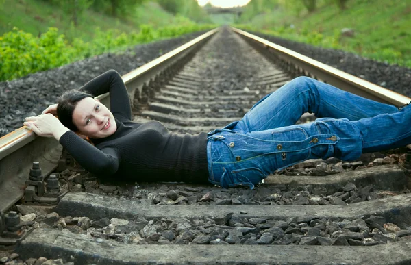Young girl lying on the railway — Stock Photo, Image