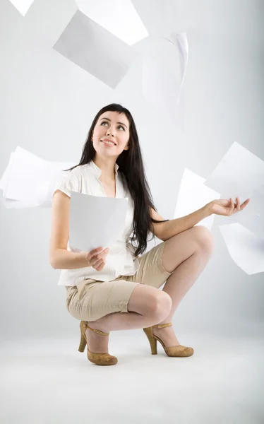 Woman and falling paper — Stock Photo, Image