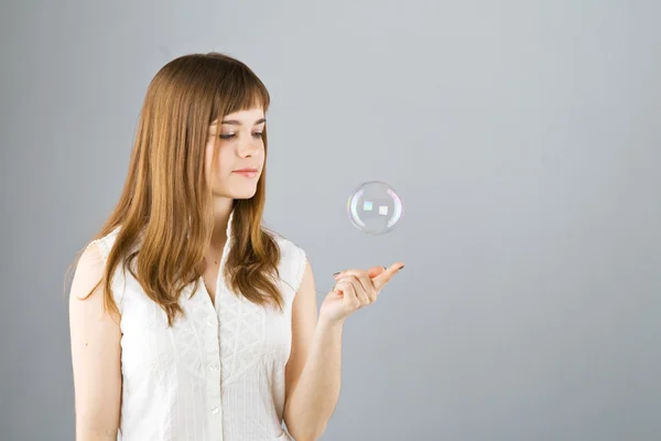 Young beautiful girl catch soap bubble — Stock Photo, Image