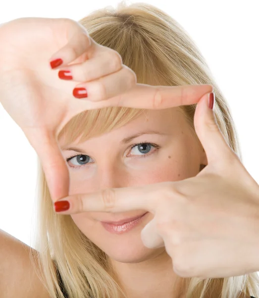 Mujer rubia joven mirando a través de un marco hecho por sus dedos — Foto de Stock