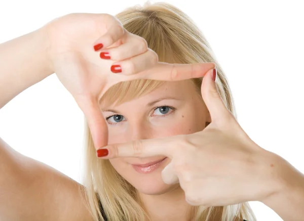 Unga blonda kvinnan tittar genom en ram av hennes fingrar — Stockfoto