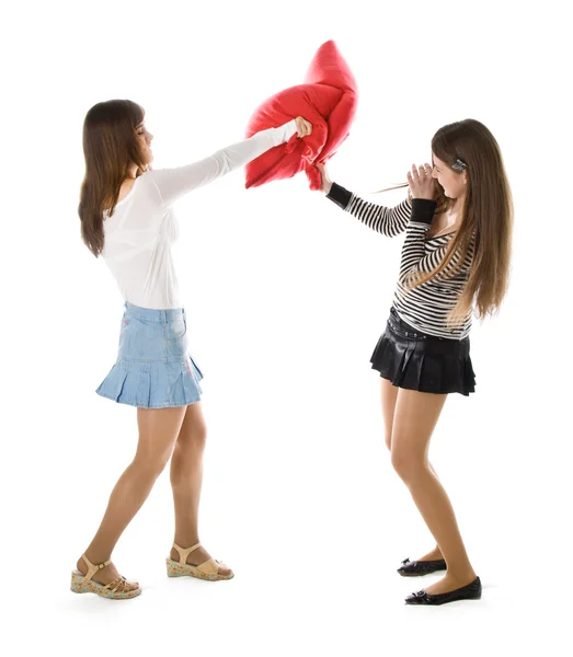 Two happy girlfriends fighting a pillows — Stock Photo, Image