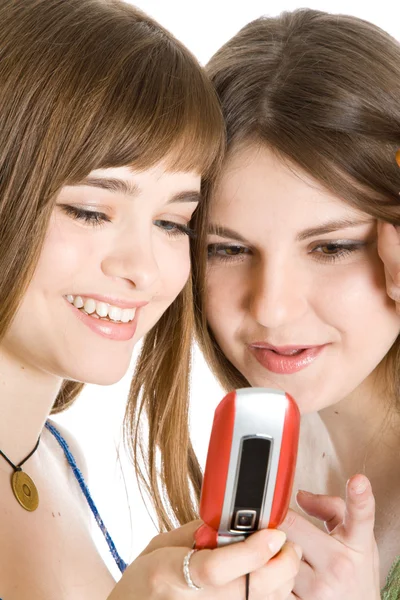 Две симпатичные девушки читают смс на мобильном телефоне — стоковое фото