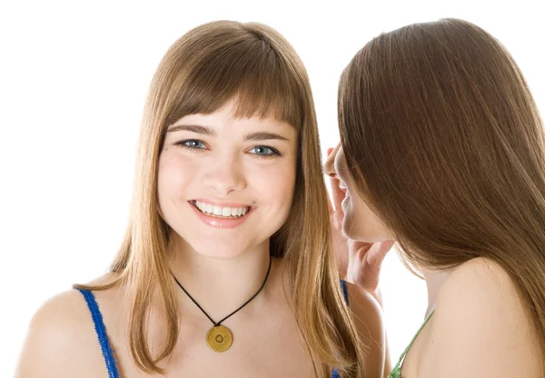 Two happy young girlfriends telling secret — Stock Photo, Image
