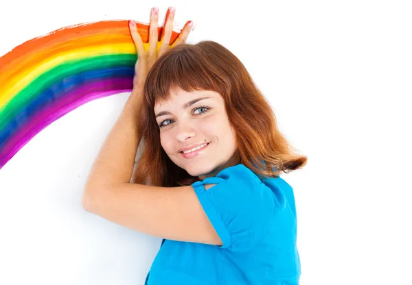 Red-haired girl draw rainbow by palm — Stock Photo, Image