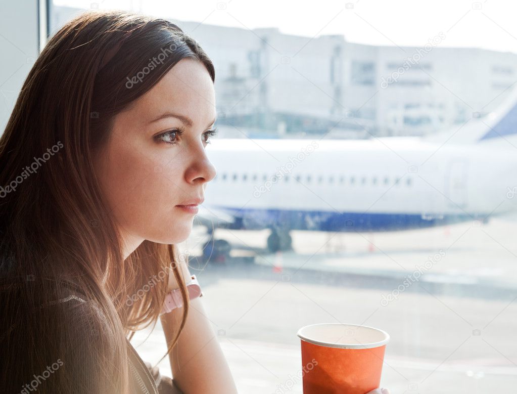 Woman drink coffee in airport