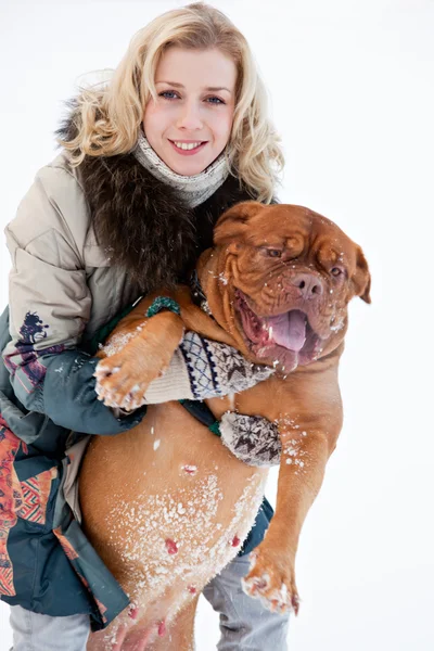 Жінка сидить на снігу зі своїм собакою — стокове фото